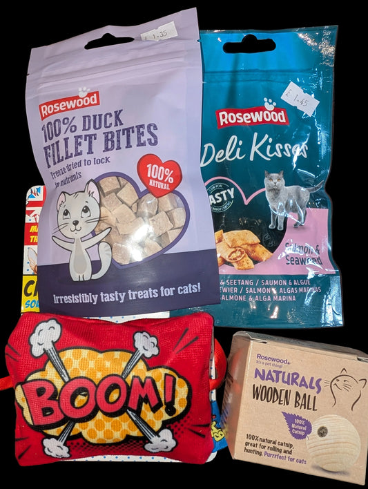 Collection of Rosewood cat treats and toys on a wooden surface